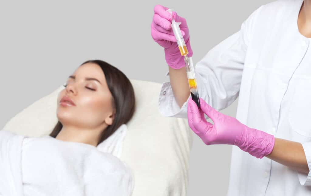 Woman lies with eyes closed, awaiting her PRP/PRF treatment at her medspa